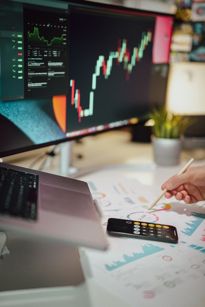 Mastering the First Impression: Your intriguing post title goes here Insightful business analytics with graphs on monitor, papers, and phone calculator.